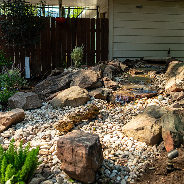 landscaping project with waterfall structure in rocks