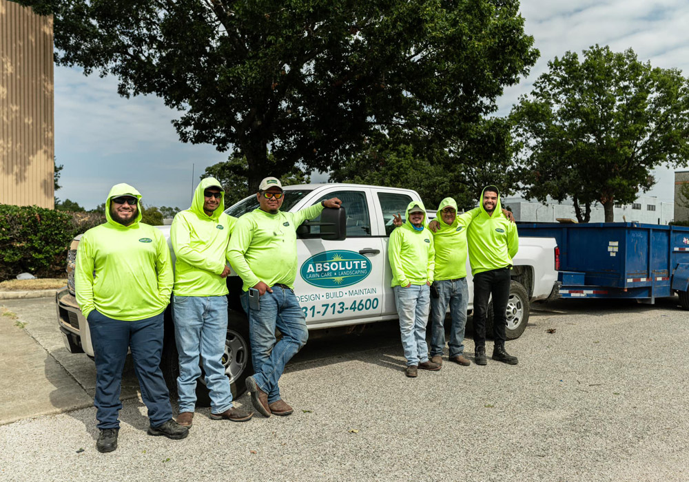 Absolute employees standing in front of work truck in parking lot