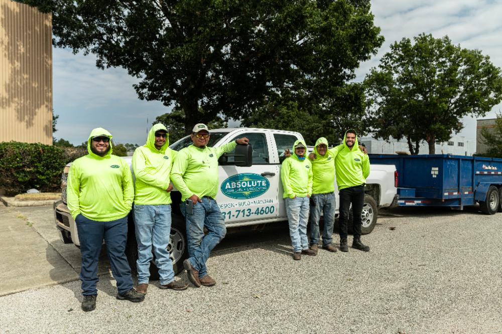 Absolute Lawn Care Team standing in front of company truck