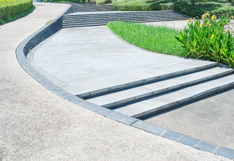 A newly installed concrete walkway with multiple steps in Houston, TX