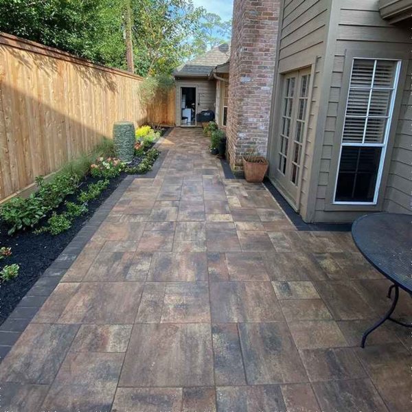 Beautifully installed stone pavers forming an elegant walkway in Houston, TX