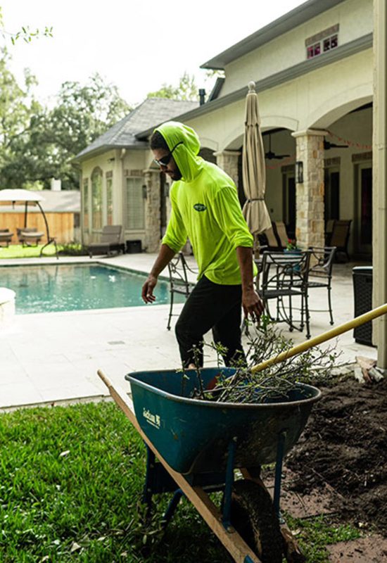 An expert is performing residential lawn maintenance service in River Oaks, TX