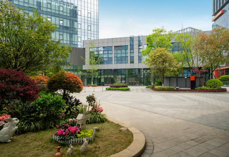 Commercial property landscape maintenance featuring clean walkways and trimmed plants in Houston, TX