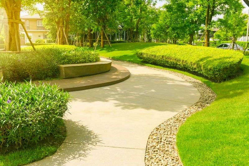 Curved park walkway with green landscaping and trees in Houston, TX