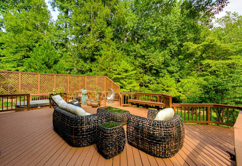Spacious wooden deck installed with outdoor seating furniture in Houston, TX