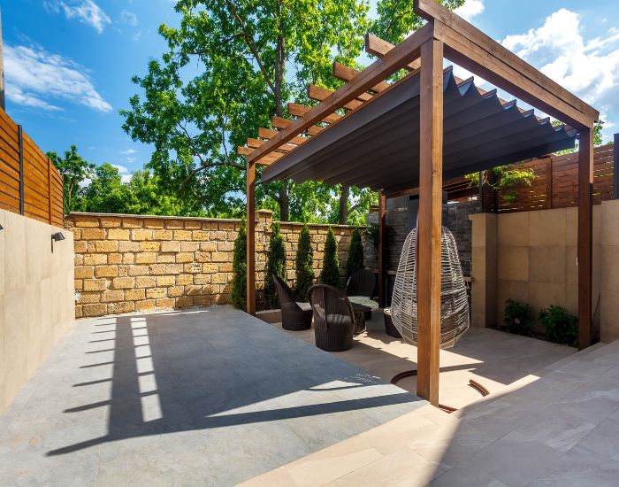 Modern wooden pergola installed with outdoor seating in Houston, TX