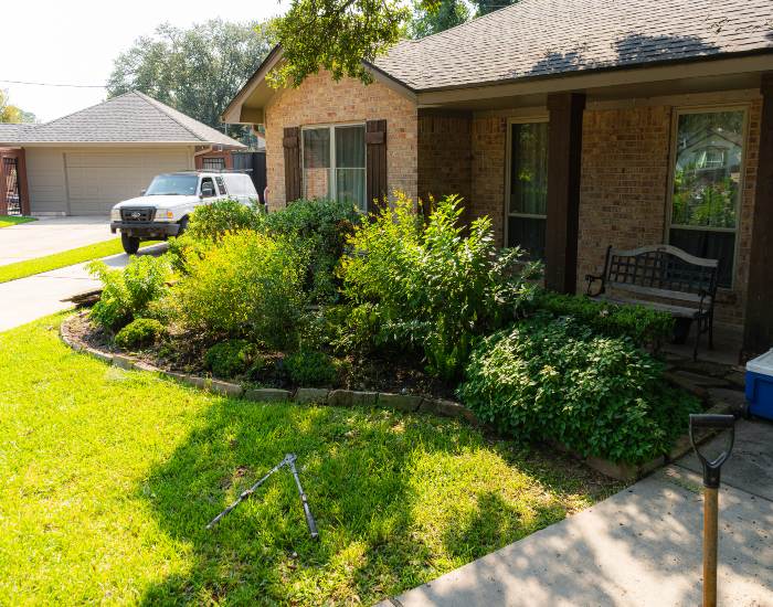 An exterior view of a front yard garden after receiving landscape maintenance services in Houston