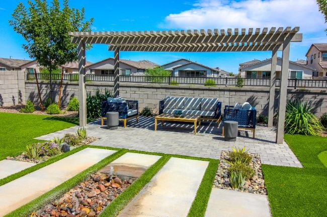 Backyard pergola creating a shaded outdoor living and entertainment space in Houston, TX.